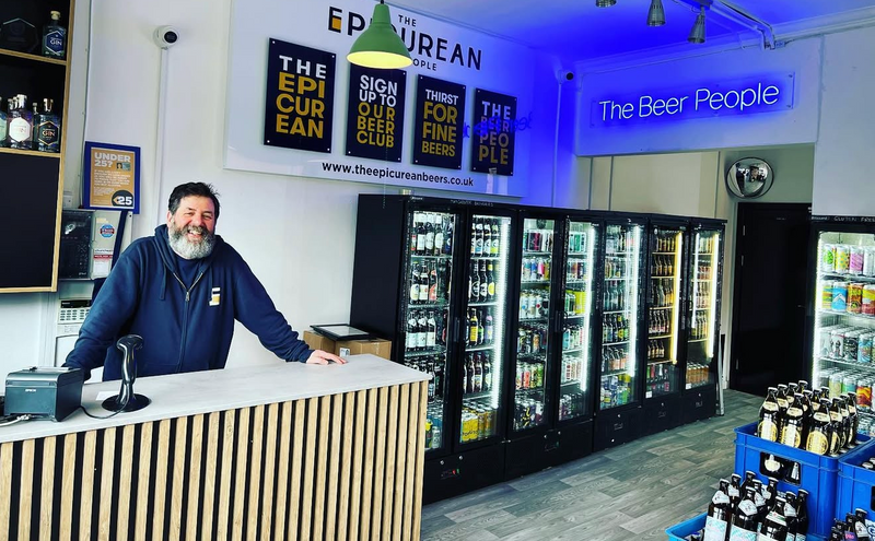 Man at the counter in the Epicurean Beer Shop