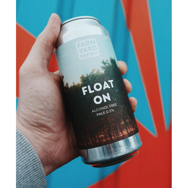 Hand holding a can of 'Float On' alcohol-free beer with a colourful background