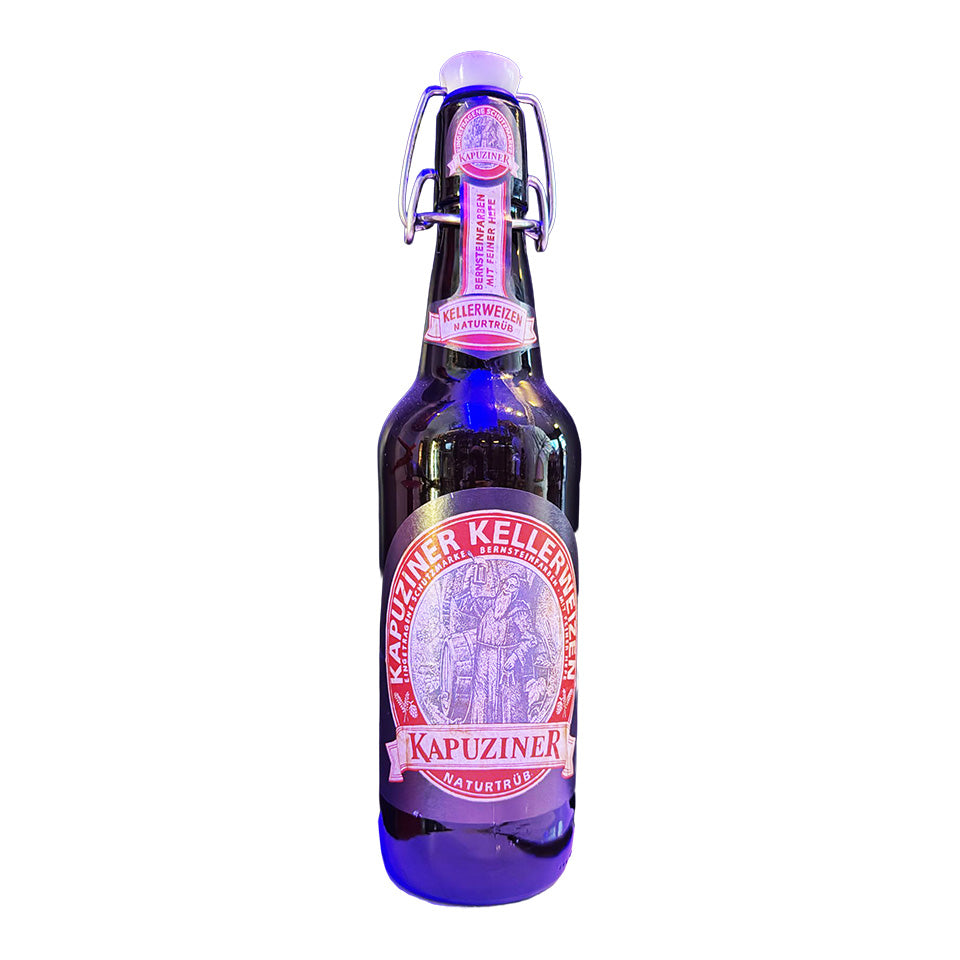 Kapuziner beer bottle with purple label on a white background
