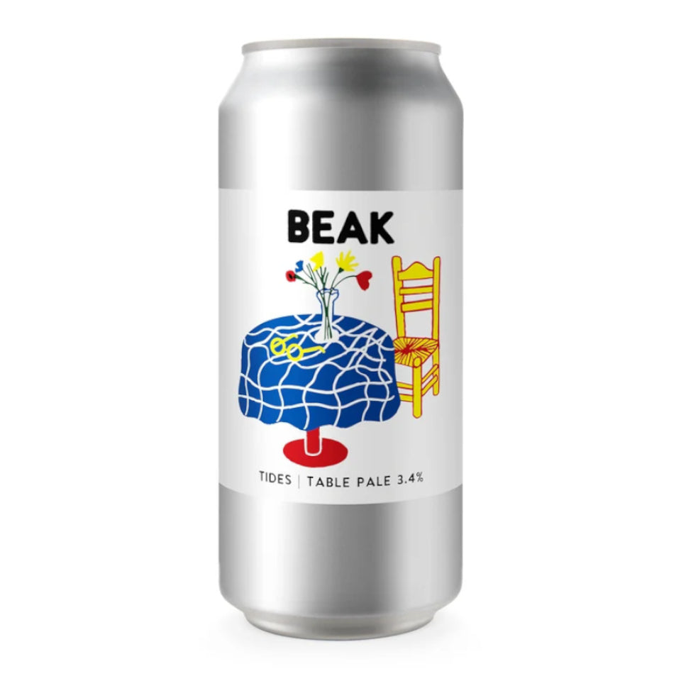 A silver aluminum beer can with a white label featuring the brand name 'BEAK' and a colorful illustration of a blue patterned table, yellow chair, and flowers. The label also reads 'TIDES | TABLE PALE 3.