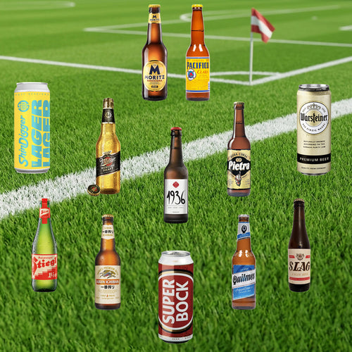 Various beer bottles and cans on a grass field background