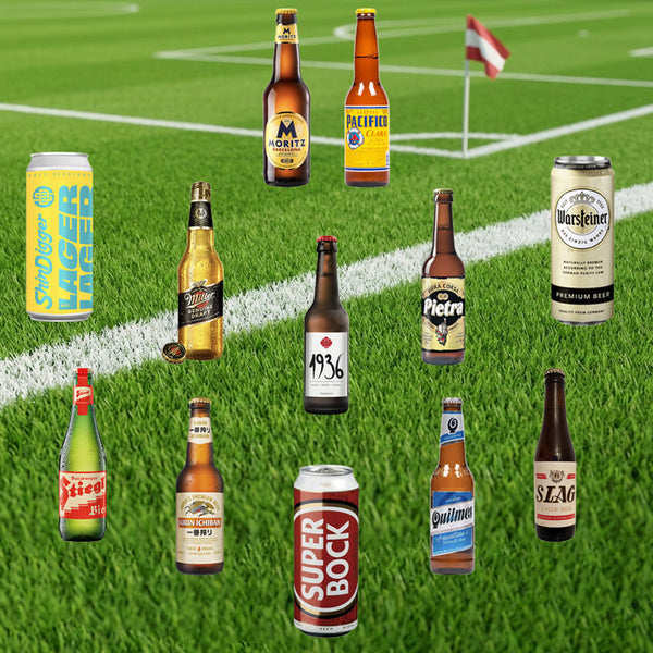 Various beer bottles and cans on a grass field background