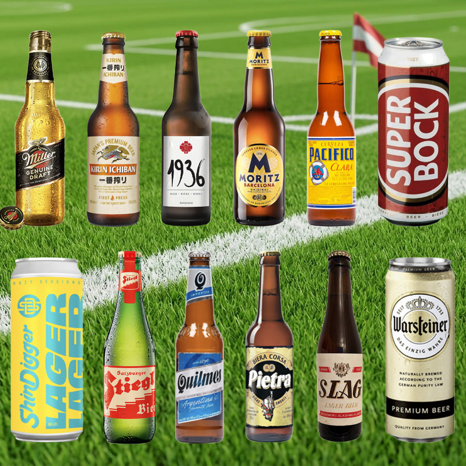 Collection of various beer bottles and cans on a grass field background