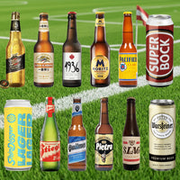 Collection of various beer bottles and cans on a grass field background