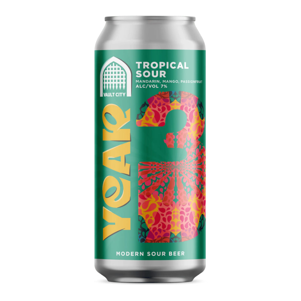 A single aluminum can of malt city tropical sour beer on a plain white background. The can features a bright green label with large yellow 'year' lettering, a colorful floral pattern, and white text reading 'TROPICAL SOUR' and 'VAULT CITY'.
